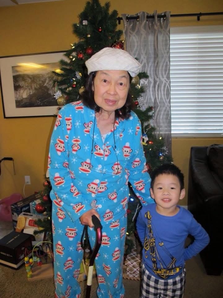 Victoria in Christmas pajamas beside a child