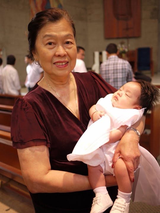 Victoria holding a baby in church