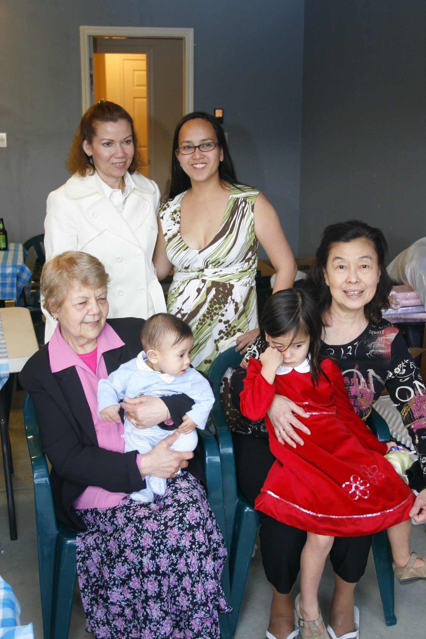 Multigenerational family gathered indoors with young children
