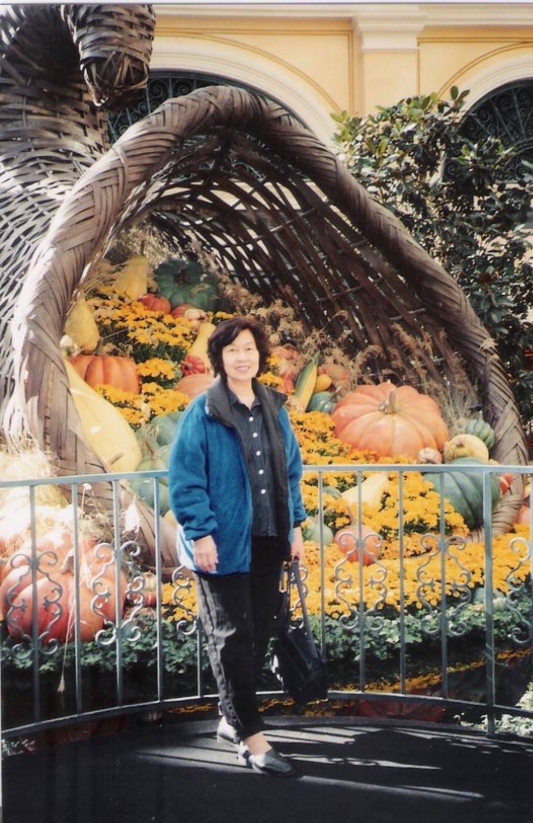 Victoria standing by an autumn harvest display