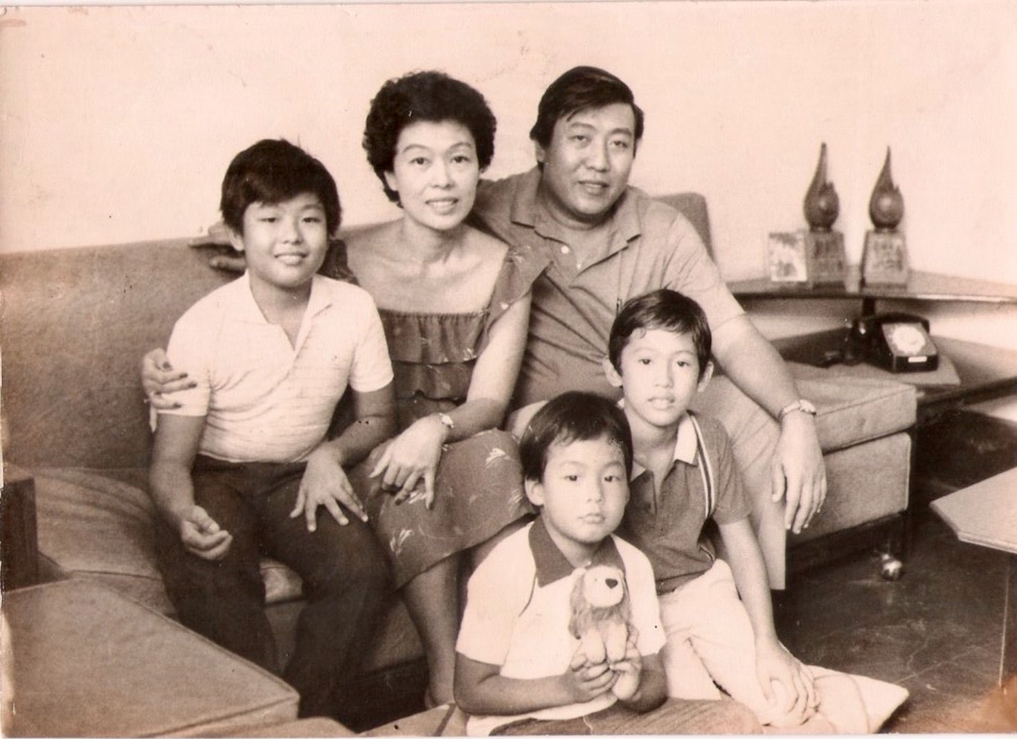 Vintage family portrait with parents and three children gathered at home