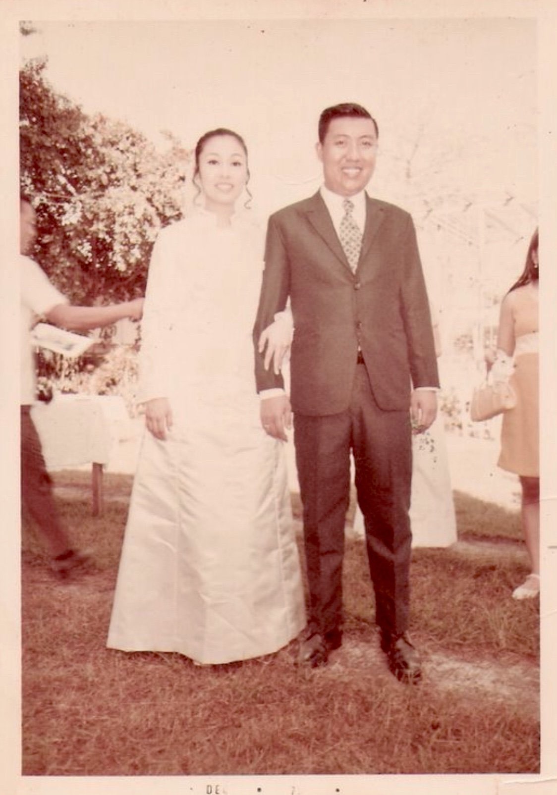Vintage formal outdoor photo of a young couple standing together