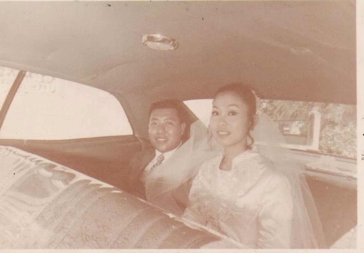 Vintage wedding day photo of a bride and groom seated together in a car